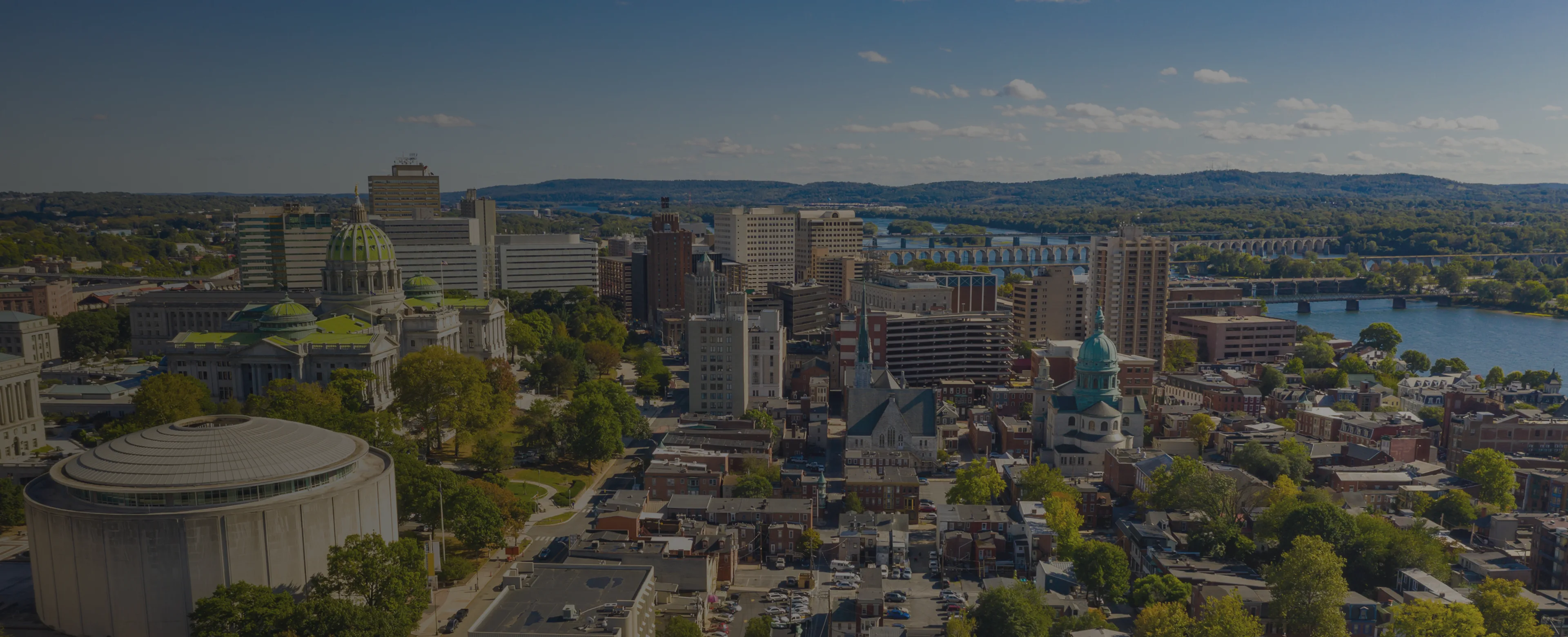 Aerial view of the Harrisburg skyline with the Pennsylvania State Capitol and Susquehanna River.